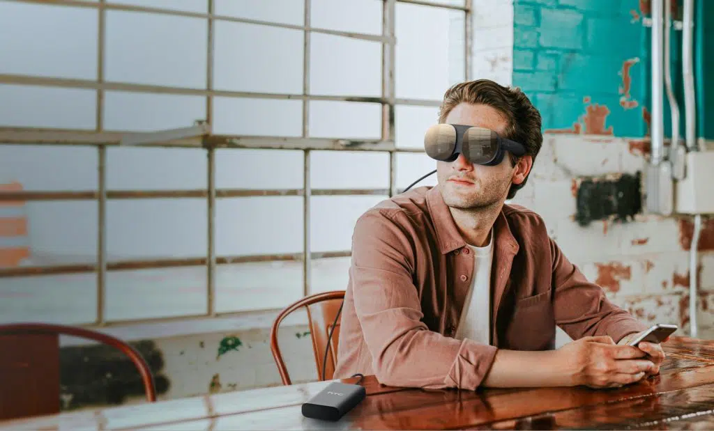 man in workspace with htc vive flow